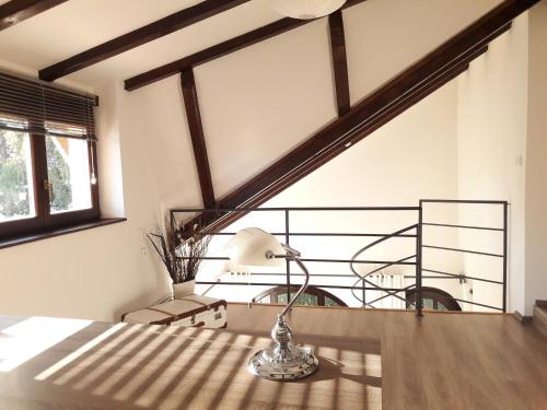 a lamp on a table in a room with a balcony at Spacious Apartment "Ana" on lake Sabljaci in Ogulin