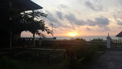 a sunset from a house with the ocean in the background at White Sands in Paje