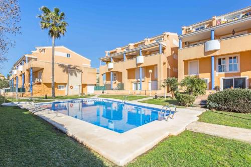 an image of a swimming pool in front of a building at Atico La Caleta in Jávea