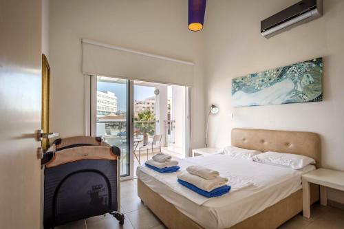 a bedroom with a bed with a fireplace and a balcony at Villa Nora in Protaras