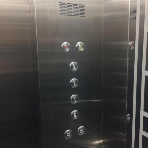 an elevator in a building with shiny metal doors at Motel Bao Linh in Vung Tau