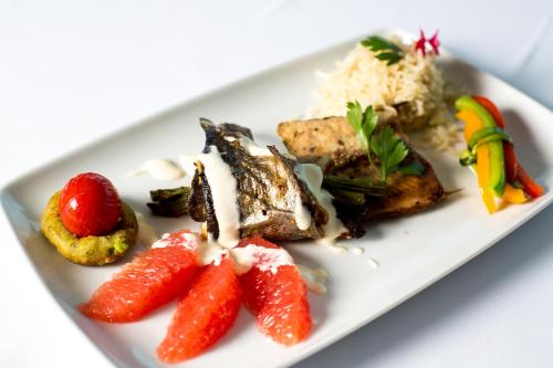 a plate of food with fruit and vegetables on it at Grand Hotel in Târgu-Mureş