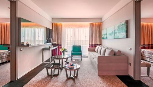 a living room with a couch and a table at Rixos Premium Belek - The Land of Legends Access in Belek