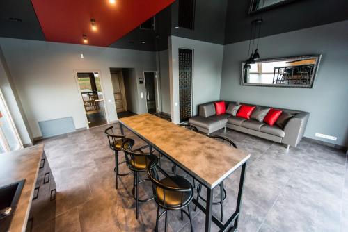 a living room with a table and chairs and a couch at Villa Orchidea in Šakiai