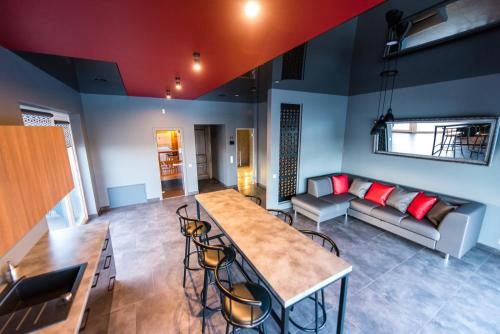 a living room with a table and a couch at Villa Orchidea in Šakiai