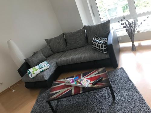 a living room with a couch and a coffee table at Ferienwohnung am Clara Park in Leipzig