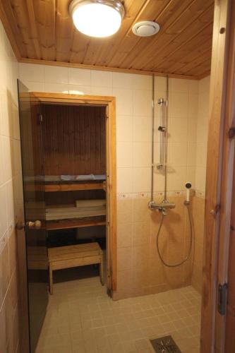 a bathroom with a shower and a shower at Villa Lotta in Virttaa