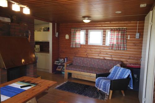 a living room with a couch and a table at Koivuniemi Cottage in Säkylä