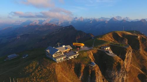an aerial view of a house on top of a mountain at Fronalpstock Hotel & Restaurant in Stoos