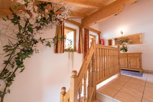a staircase in a house with flowers on the wall at Appartement Alpina in Alpbach