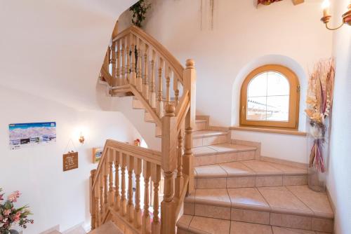 a spiral staircase in a home with a window at Appartement Alpina in Alpbach