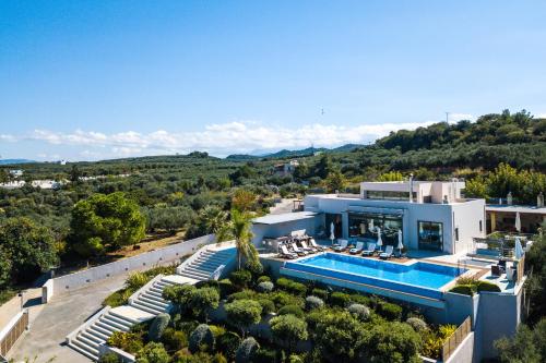 an aerial view of a house with a swimming pool at Winehill Villa in Platanias