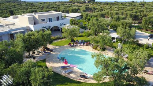 an aerial view of a swimming pool in front of a house at Isola Verde Agriturismo in Carovigno