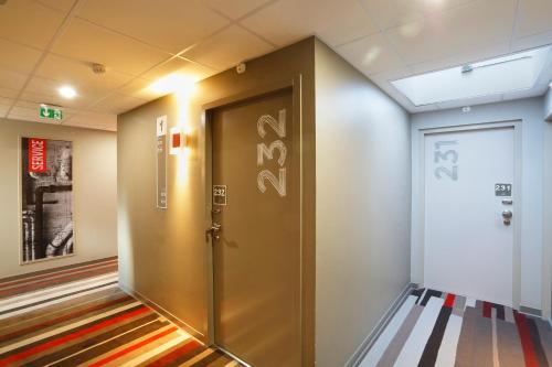 a hallway with a elevator in a building at ibis Le Mans Est Pontlieue in Le Mans