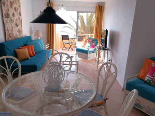 a living room with a glass table and chairs at Venturamar in Gran Tarajal