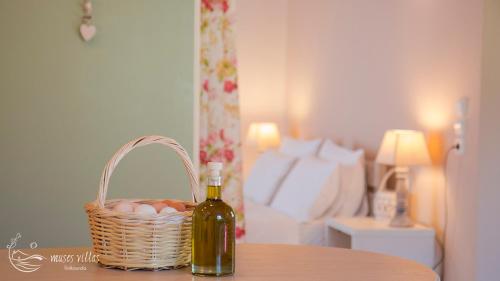 a bottle of wine and a basket of eggs on a table at Muses Villas in Finikounta