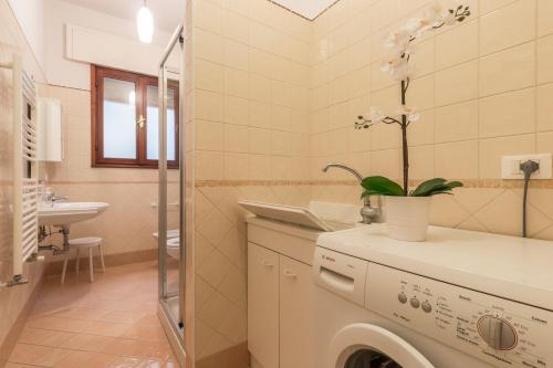 a bathroom with a washing machine and a sink at Rialto Bridge Big apt with Lift by LionHost in Venice