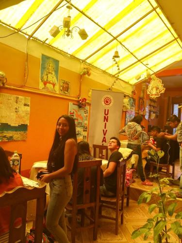 a woman standing in a room with a group of people at Hostal Puerto Alegre in Copacabana