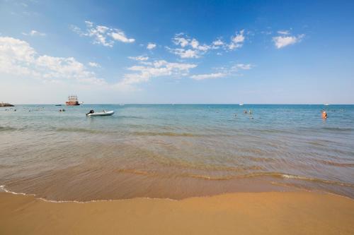 a group of people in the water at the beach at Side Sunport Hotel - All Inclusive in Side