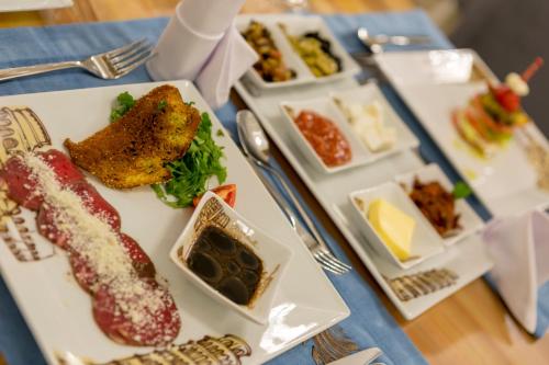 a table with plates of food on a table at Side Sunport Hotel - All Inclusive in Side
