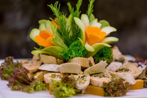 a plate of food with flowers on top of it at Side Sunport Hotel - All Inclusive in Side