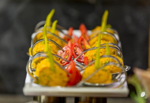 a tray of fruit with peppers on a table at Side Sunport Hotel - All Inclusive in Side