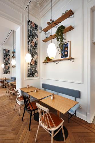 a row of tables and chairs in a restaurant at Hygge Hotel in Brussels