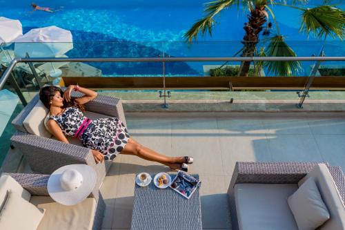 a woman sitting in a chair in a pool at Side Sunport Hotel - All Inclusive in Side