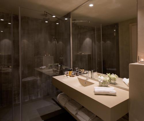 a bathroom with a sink and a shower at Palmon Bay Hotel & Spa in Herceg-Novi