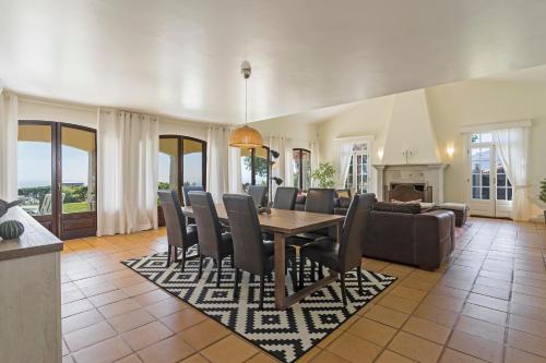 a living room with a dining table and chairs at Vila Eucalipto by An Island Apart in Funchal