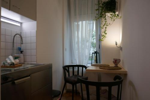 a kitchen with a small table and two chairs at Apartments Nähe Hauptbahnhof in Berlin