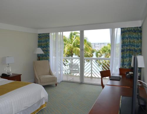 a hotel room with a bed and a large window at Lighthouse Pointe at Grand Lucayan Resort in Freeport