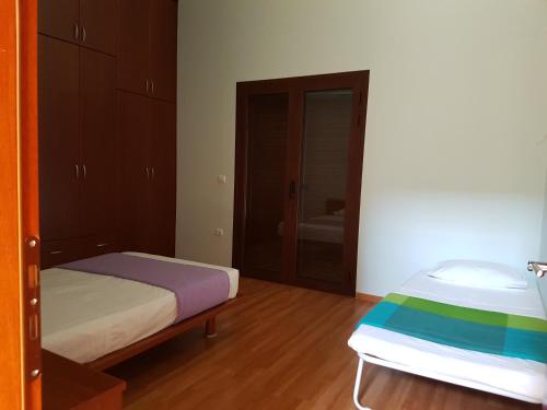 a bedroom with a bed and a door to a bathroom at Dimitris Villa in Aígio
