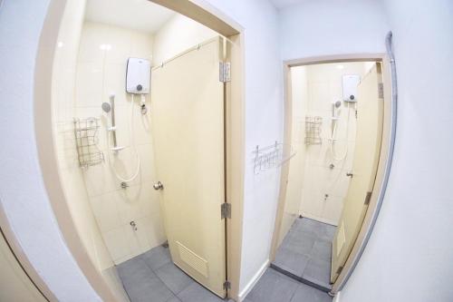 a bathroom with a mirror and a walk in shower at Inn Trog And Inn Soi in Bangkok