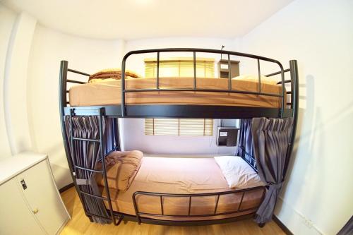 two bunk beds in a small room at Inn Trog And Inn Soi in Bangkok