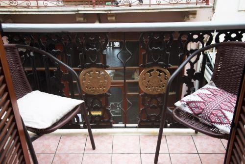 a pair of chairs sitting on a balcony at Diporto in Chania Town