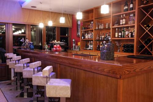 a bar with a bunch of chairs in a room at Boutique Hotel Parnassia in Arachova