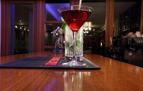 a drink in a glass sitting on a table at Boutique Hotel Parnassia in Arachova
