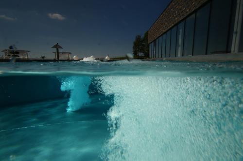 a person in a swimming pool at night at Termy Warmińskie in Lidzbark Warmiński