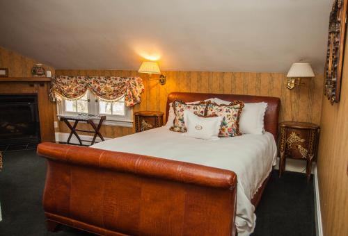 a bedroom with a large bed with a leather couch at Antrim 1844 in Taneytown