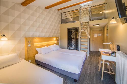a hotel room with two beds and a desk at Archipel Volcans in Saint-Genès-Champanelle