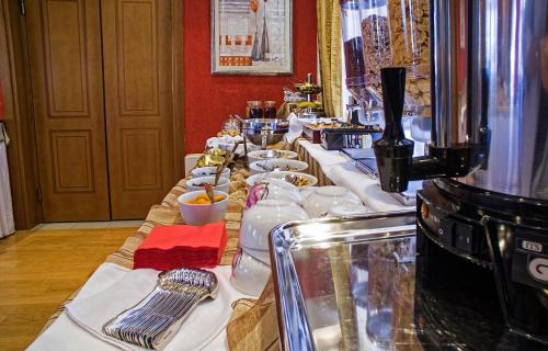 a long buffet line with plates and bowls of food at Boutique Hotel Parnassia in Arachova