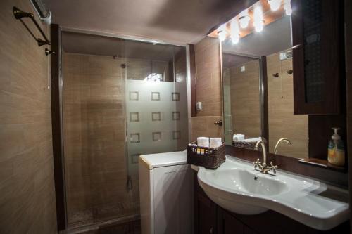 a bathroom with a sink and a shower at Petra house in Arachova