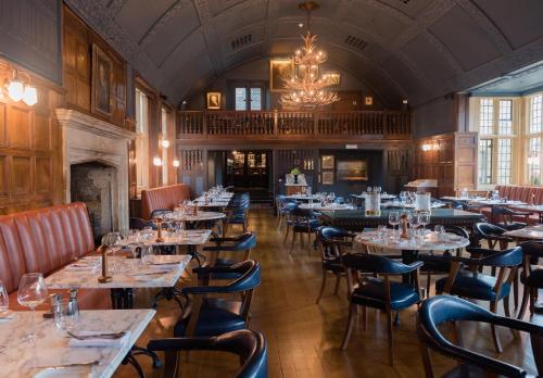 a restaurant with tables and chairs in it at The Lygon Arms Hotel in Broadway