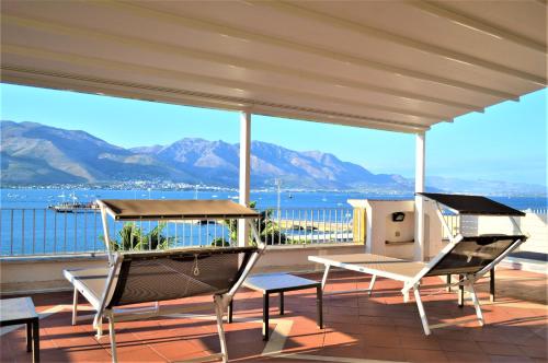 a balcony with a view of the water and mountains at Hotel Gajeta in Gaeta