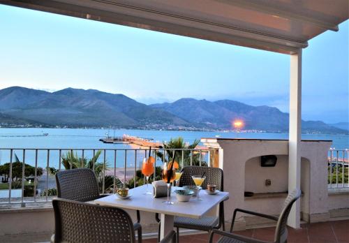 a table on a balcony with a view of the water at Hotel Gajeta in Gaeta