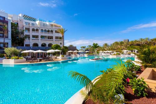 a large swimming pool in front of a hotel at Gran Tacande Wellness & Relax Costa Adeje in Adeje