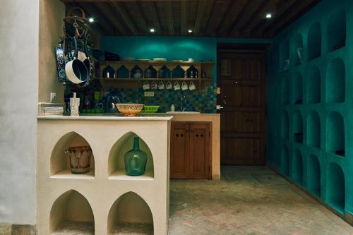 a kitchen with a table with a green vase on it at Dar Saida in Fez