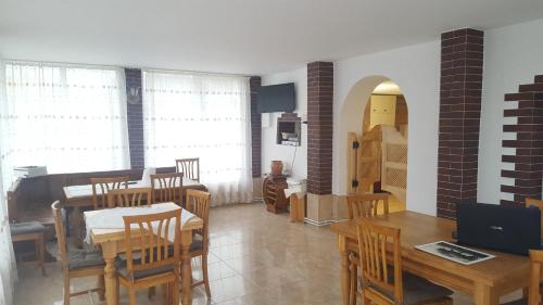 a dining room with a table and wooden chairs at Belvedere La Cristina in Corbeni