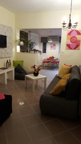 a living room with a couch and a table at City Space Apartments in Giannitsa